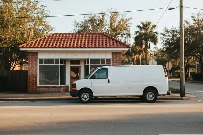 Mobile locksmith service van parked outside a small business storefront in Valdosta GA